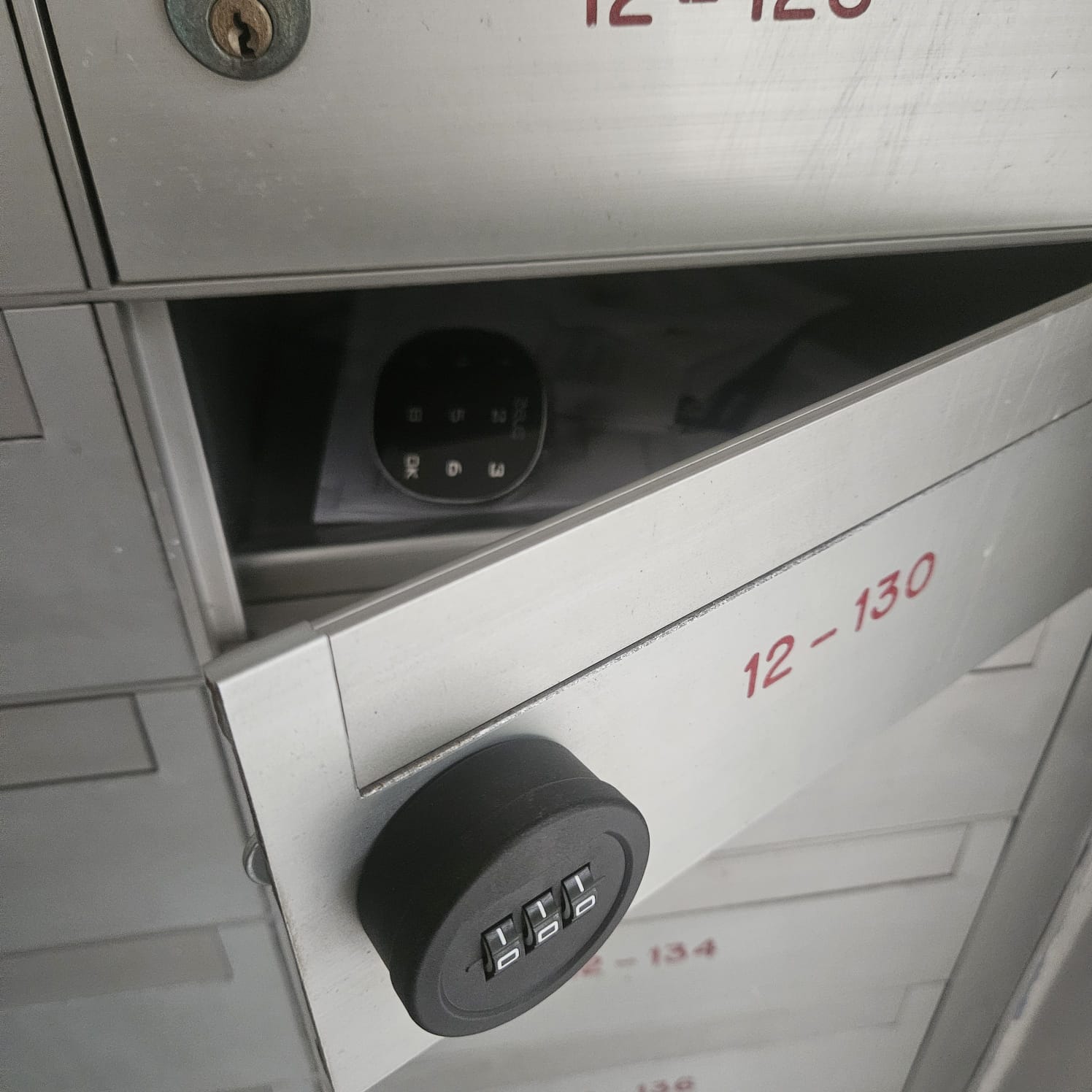Silver keyed lock fitted to a standard HDB letterbox door